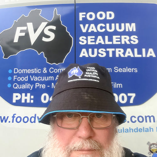 Person wearing a branded cap in front of a 'Food Vacuum Sealers Australia' sign.