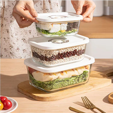 Set of 3 glass vacuum canisters being stacked in a kitchen
