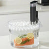 Sous vide cooker cooking salmon in a plastic container