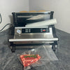 Vacuum sealer with a piece of meat on a countertop